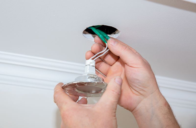 Handyman installing a light fixture